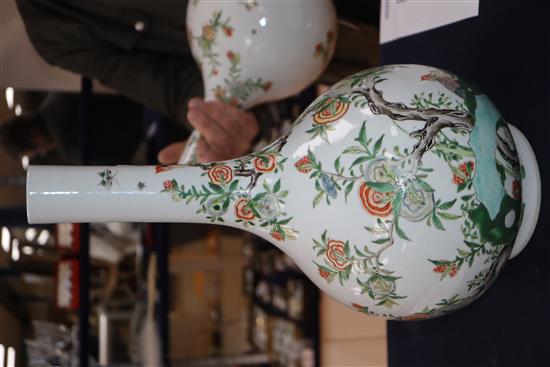 A pair of Chinese enamelled porcelain bottle vases, each painted with Birds of Paradise amid blossoming branches and rockwork, height 3